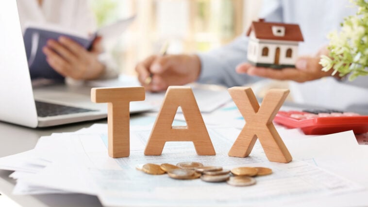 Estate planning documents and calculator representing taxation of estates in Florida